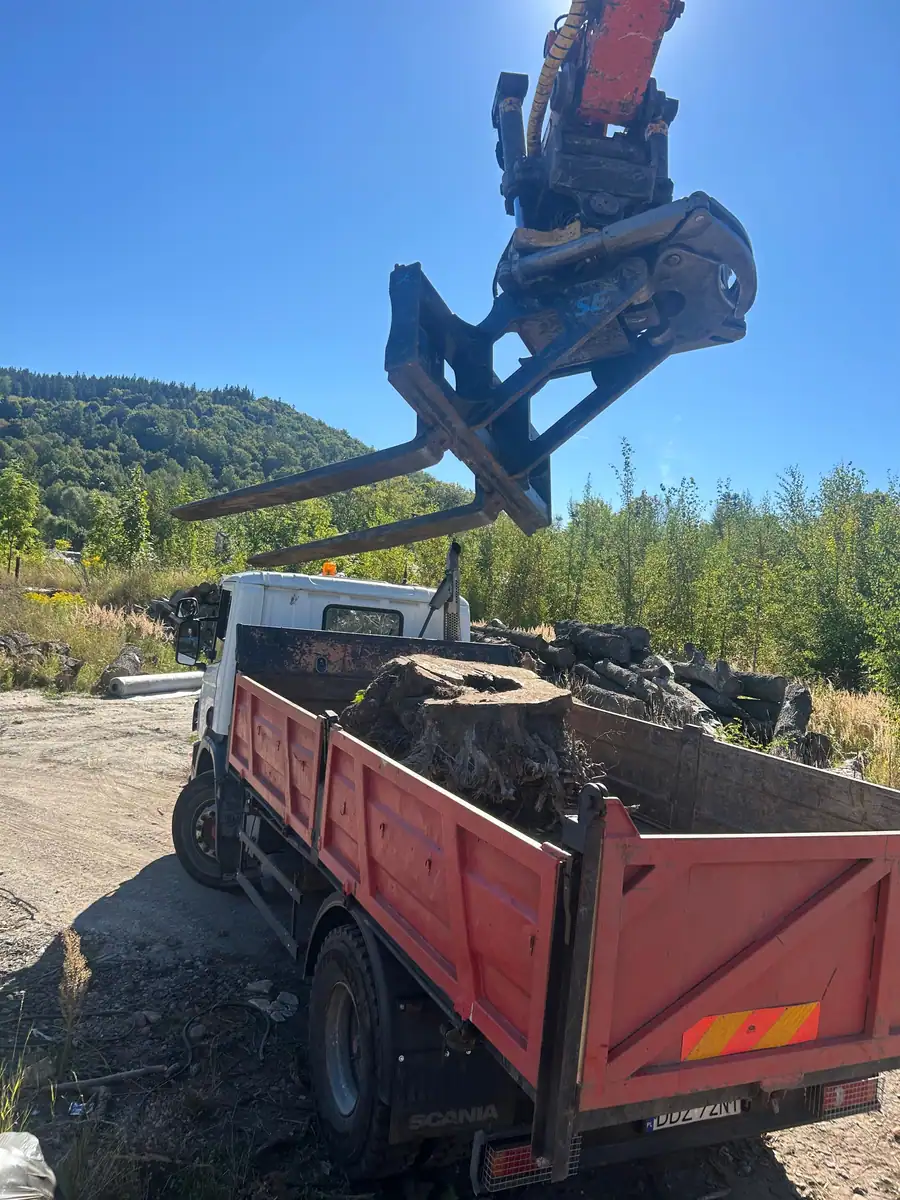 Chwytak koparki Hitachi Zaxis 140W ładuje karpinę na wywrotkę Scania 220 4×2